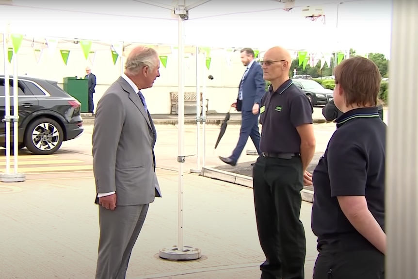 Prince Charles speaking to a supermarket employee