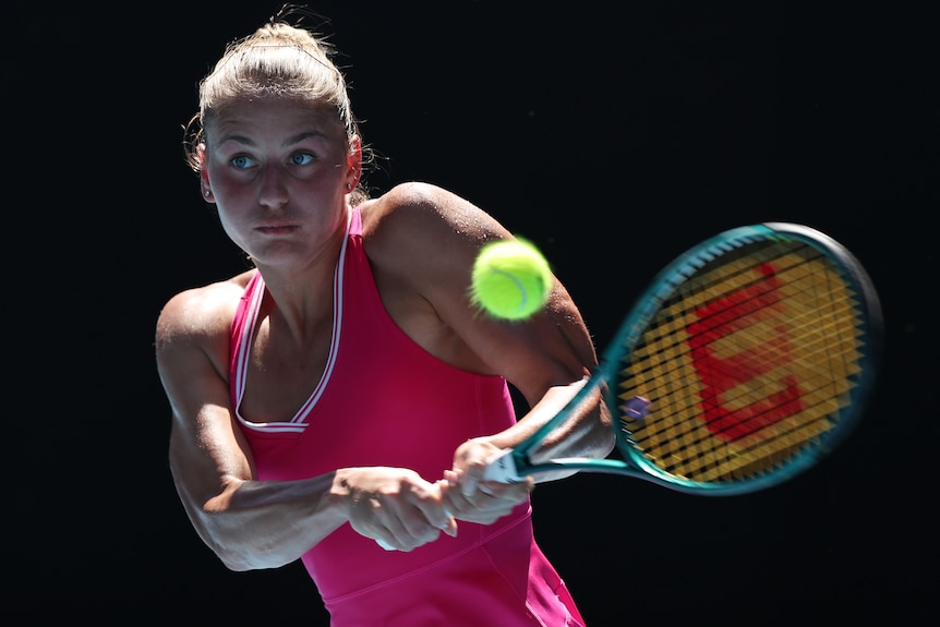 Marta Kostyuk plays a double-fisted backhand at the 2024 Australian Open.