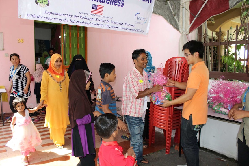 Rohingya families look happy as they attend a community event.