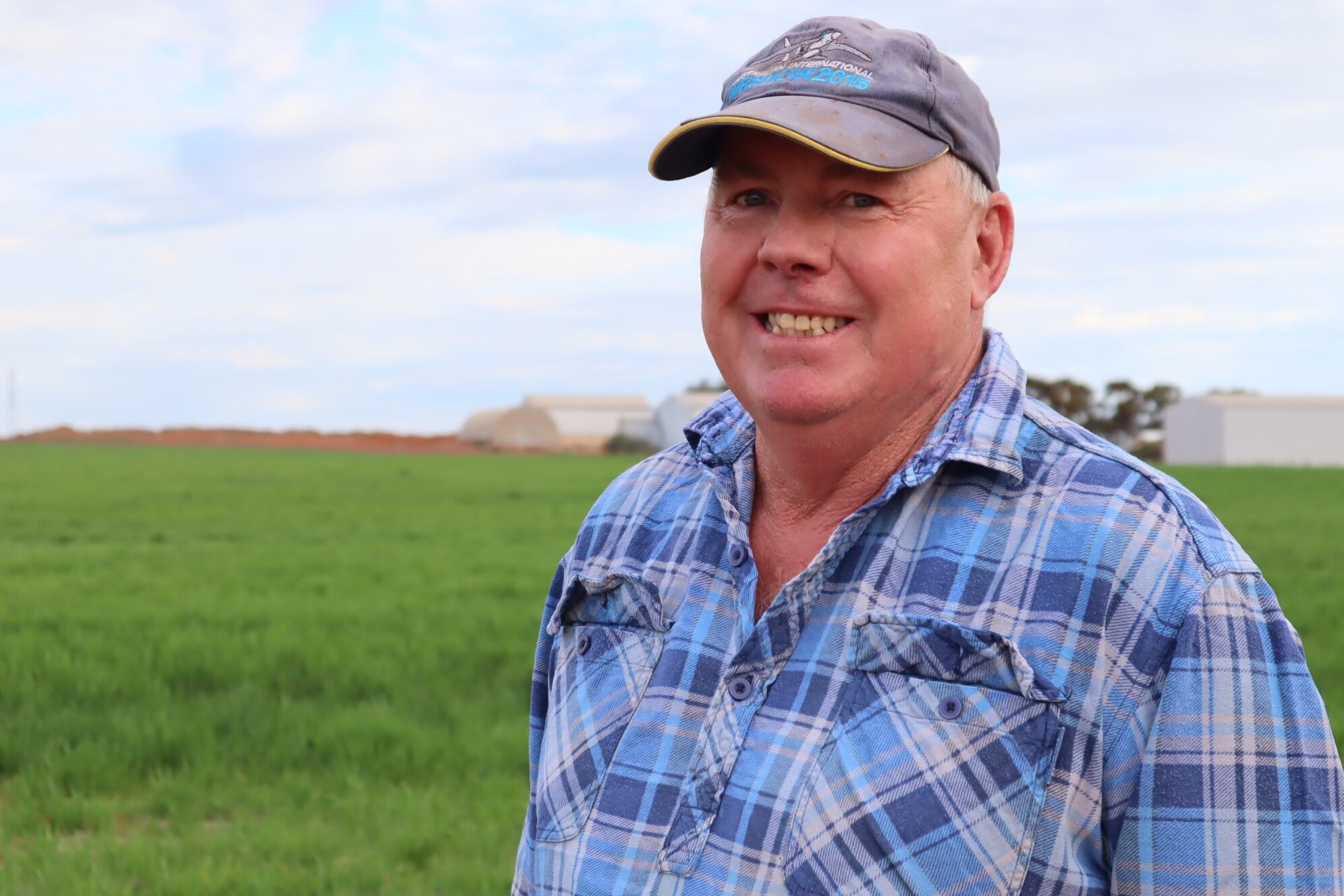  Farmer in checkered shirt in paddock