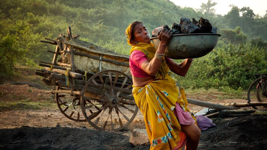 One of India's Indigenous Adivasis miners hauls coal.