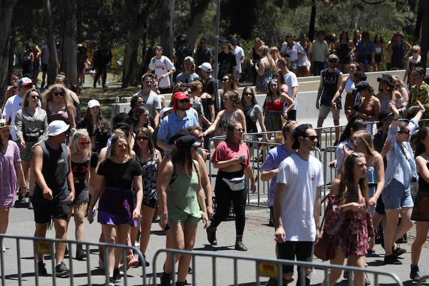 People stream into the festival gates.