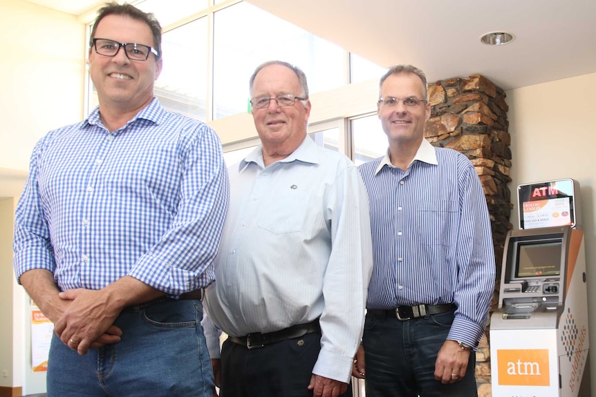 Simon Lyons, Doug Stead and Todd Zani with the new Recycler ATM.