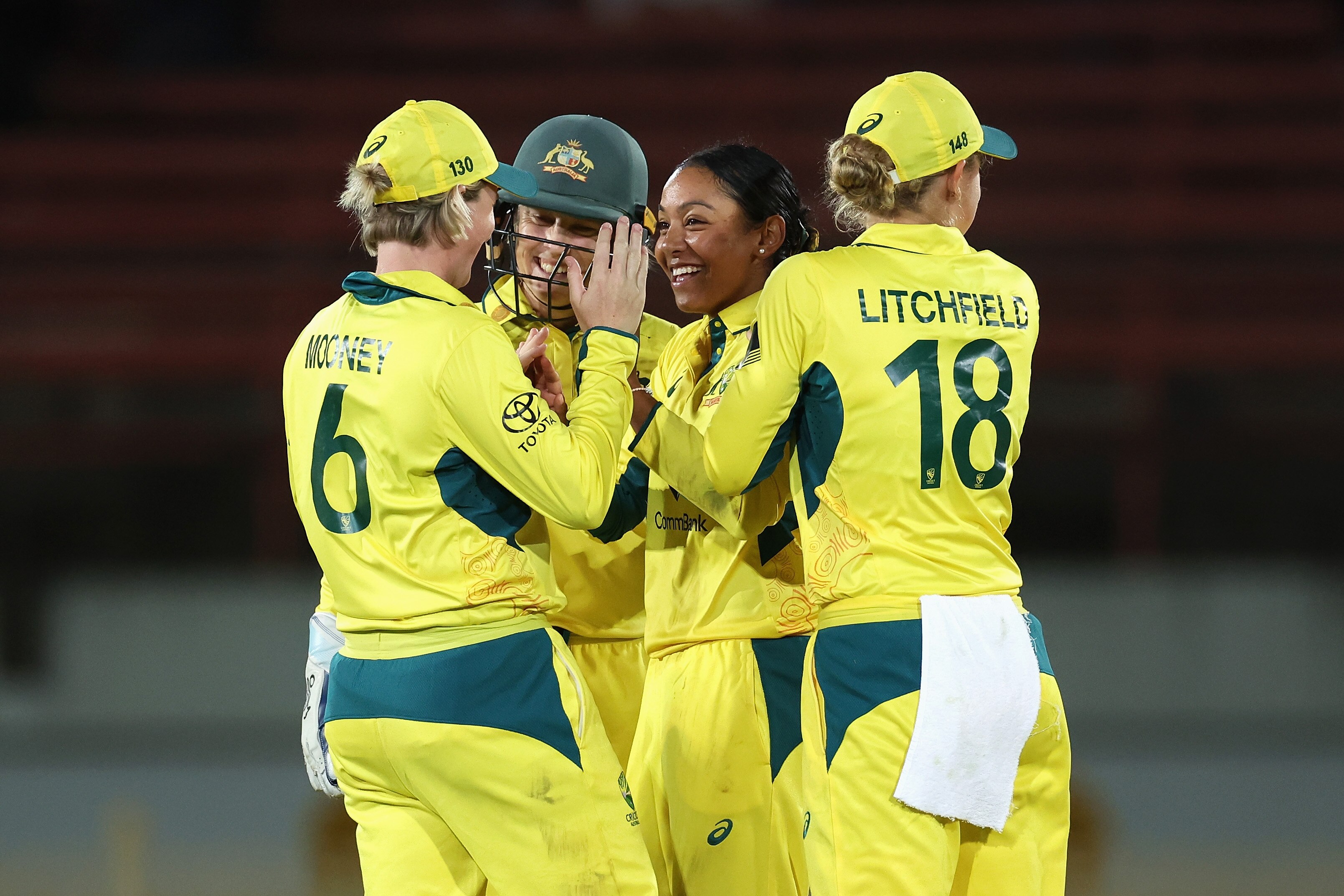 Alana King smiles as she is congratulated by teammates