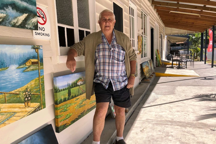 Shop owner Barry Hawke stands outside a store under a street awning at Woolooga.