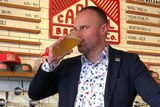 ACT Chief Minister Andrew Barr drinking a beer at Capital Brewing Co.