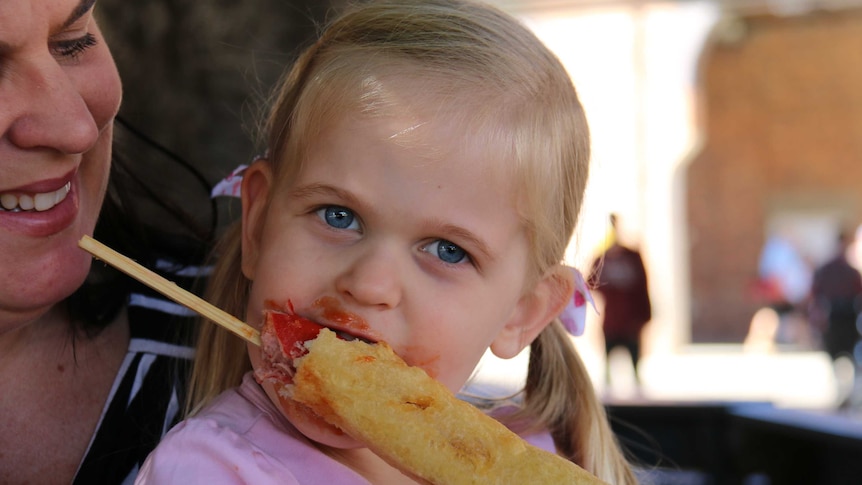 Lily Auld enjoys a dagwood dog