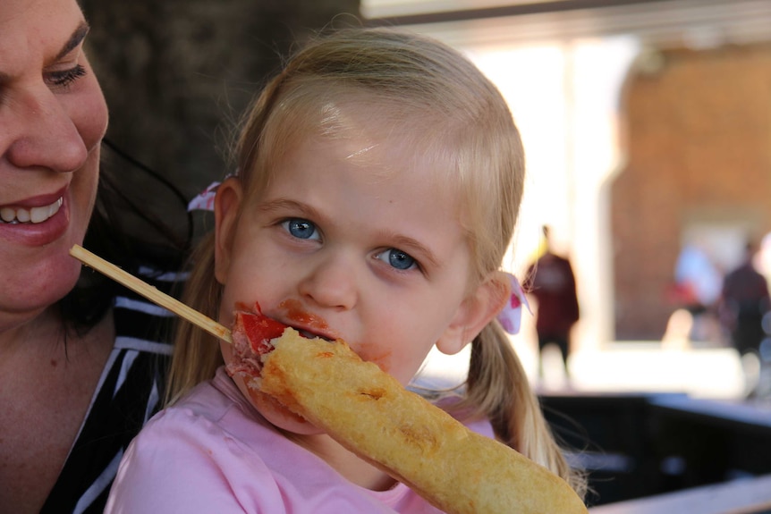 Lily Auld enjoys a dagwood dog