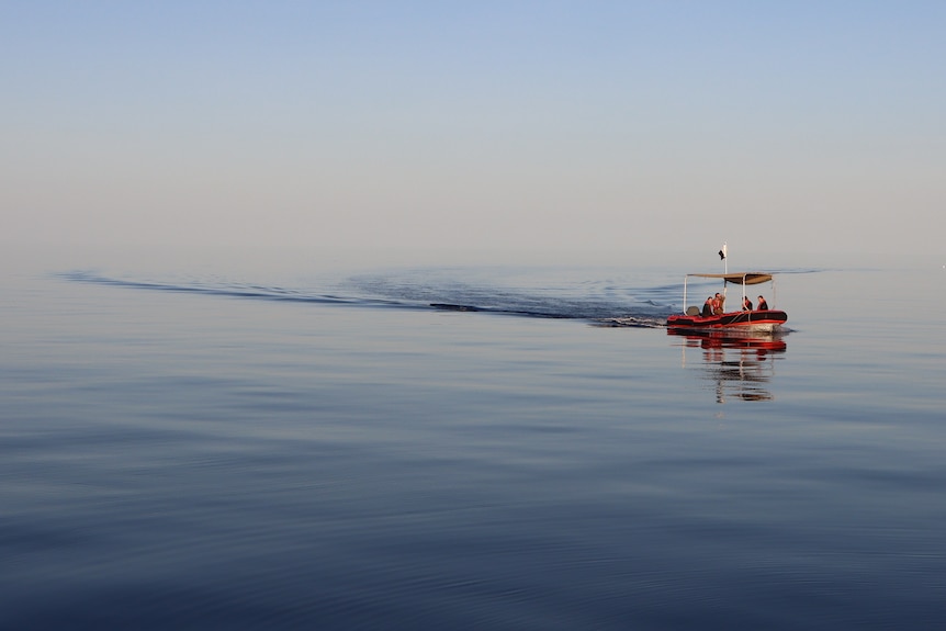 Boat on glassy, empty water