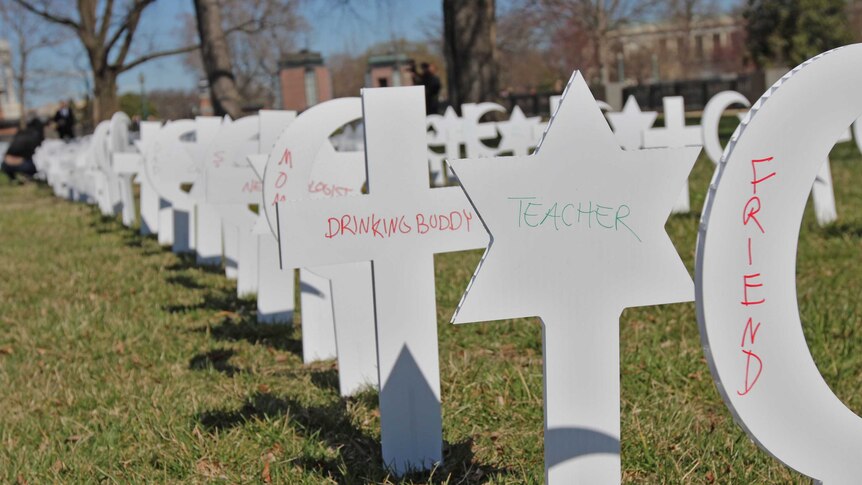 Cut-outs bearing religious symbols that have the words 'teacher', 'friend' and others on them.
