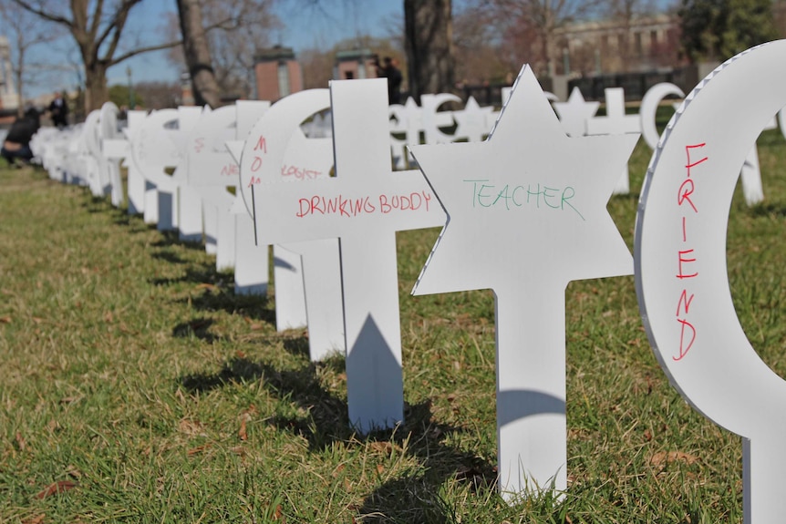 Cut-outs bearing religious symbols that have the words 'teacher', 'friend' and others on them.