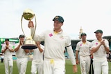 Australian captain Steve Smith holds the Border-Gavaskar Trophy after day five at the SCG.