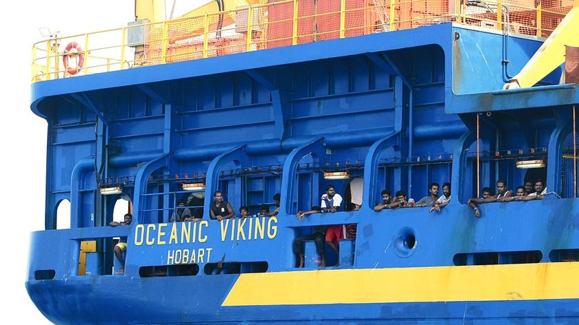 Sri Lankan asylum seekers look out from the Australian coast guard vessel Oceanic Viking