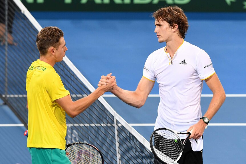 Alex de Minaur and Alexander Zverev shakes hands at the net following their Davis Cup rubber in Brisbane.