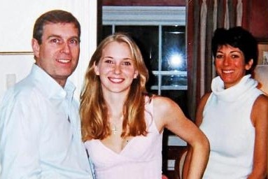 A man and two women stand in a house looking at the camera.