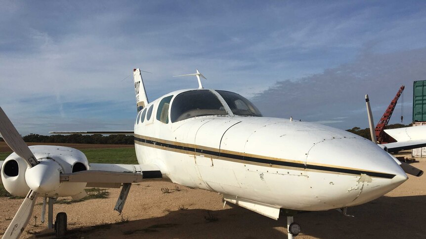 Twin-engined Cessna 402 aircraft parked on Mallee farm