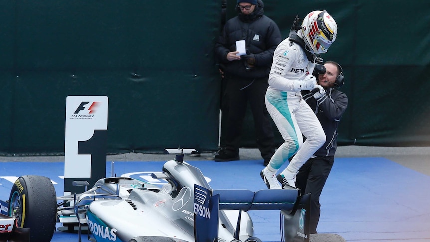Lewis Hamilton jumps out of cockpit after winning in Canada