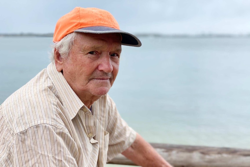 An elderly man near a beach.