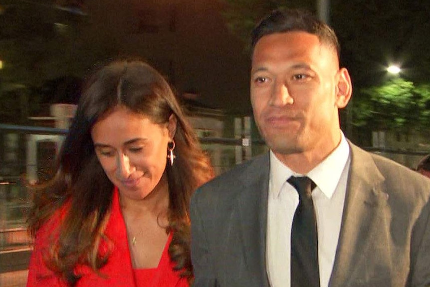 Israel Fola walking with is wife Maria Folau at night.