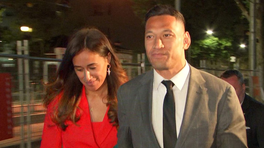 Israel Fola walking with is wife Maria Folau at night.