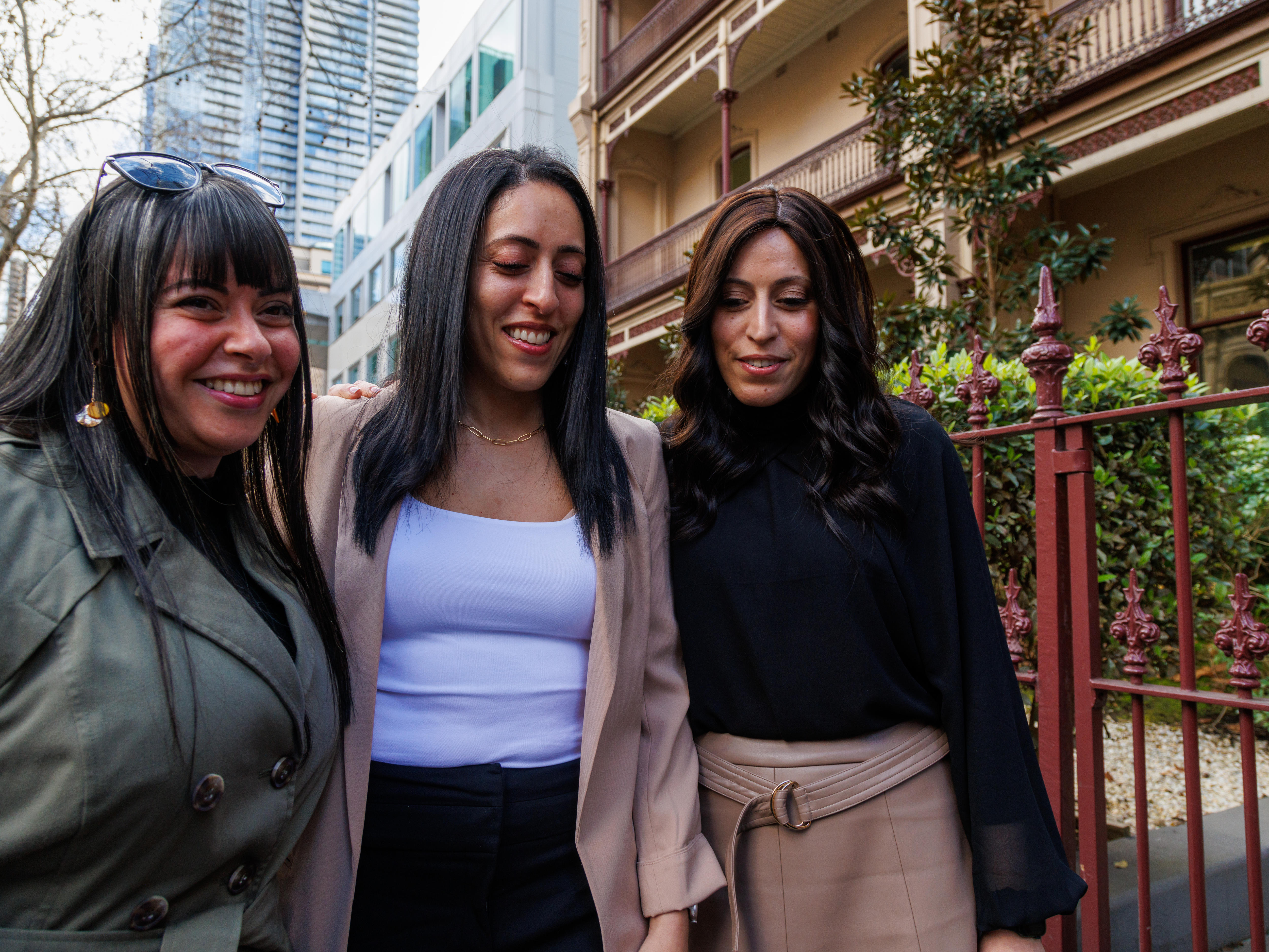 Three women outside a terrace house