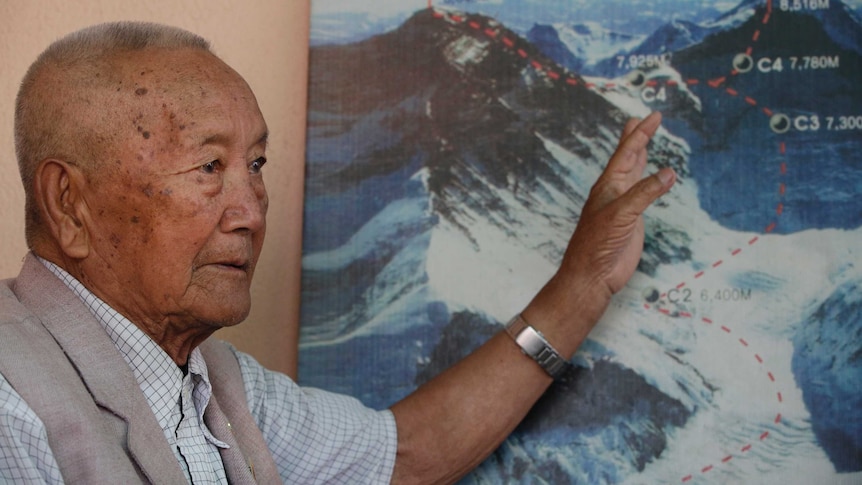Nepalese climber Min Bahadur Sherchan, points to a picture to describe the trail to Mount Everest