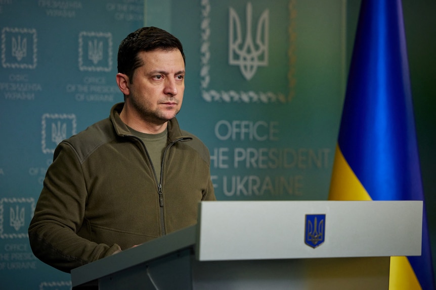 Ukraine President looking tired speaks at podium.