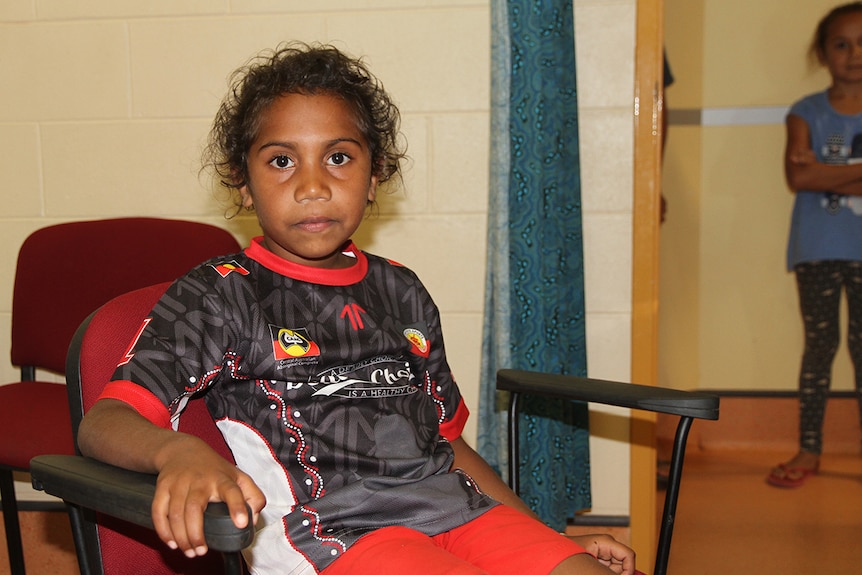 Six-year-old Rexena awaits her vaccination for meningococcal disease.