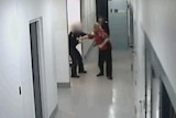 Security footage shows police using capsicum spray and kicking woman in custody.