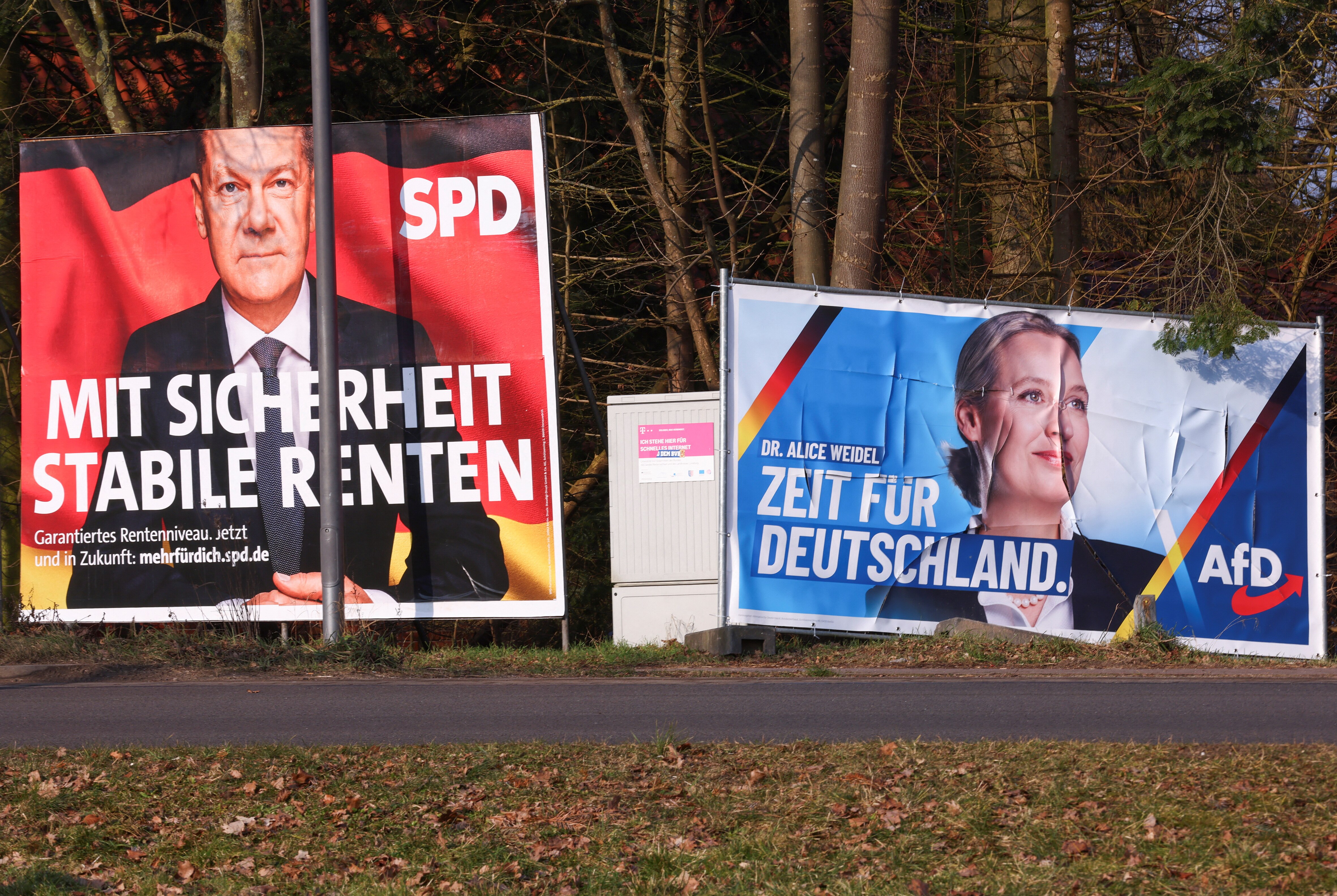 Election campaign posters show the faces of a man and a woman.