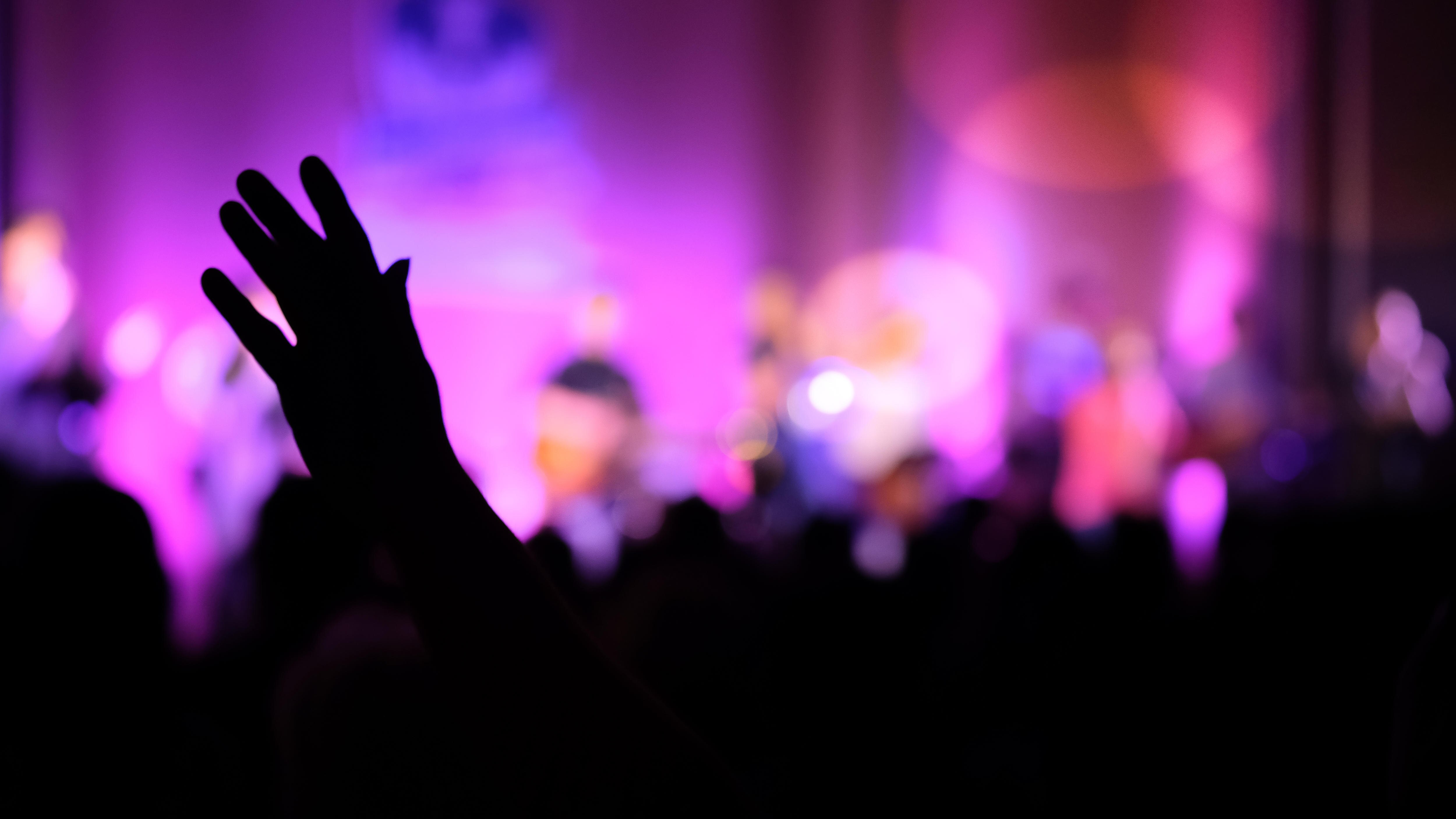Worshipper raising a hand during a modern church service