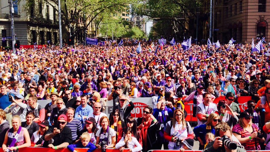 Thousands of fans watch the finishes moments of the AFL Grand Final Parade.