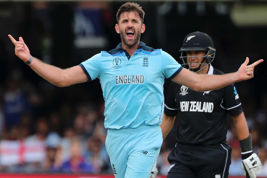 Liam Plunkett holds his arms wide and yells. Ross Taylor is looking on behind him.