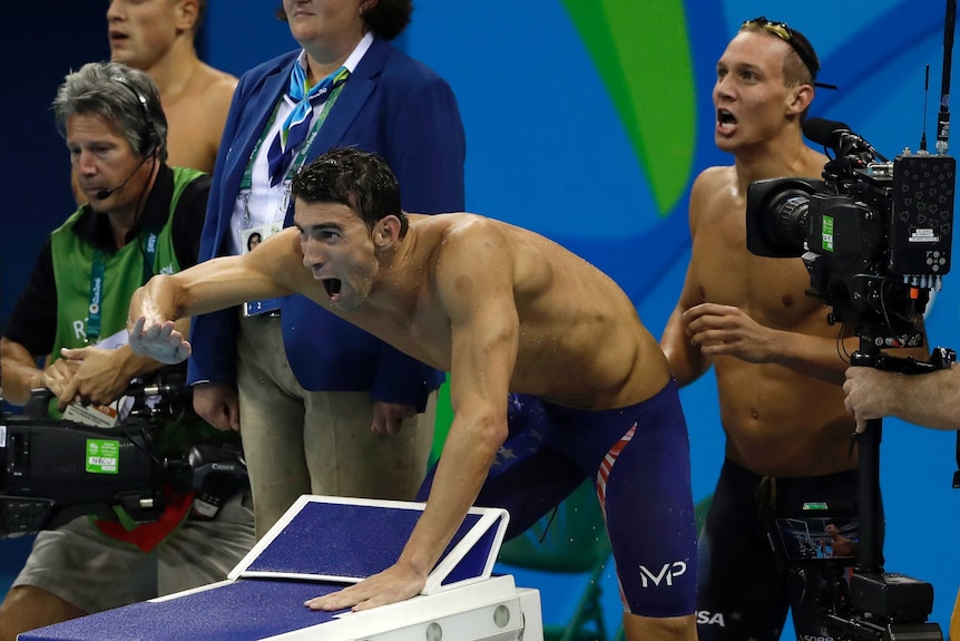 Michael Phelps encourages his team-mates in 4x100m freestyle relay