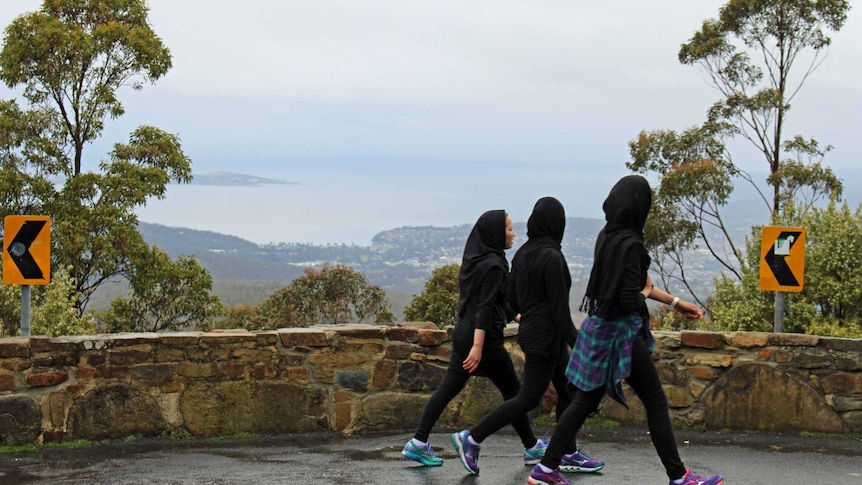 Young refugee women walk on Mount Wellington