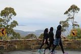 Young refugee women walk on Mount Wellington