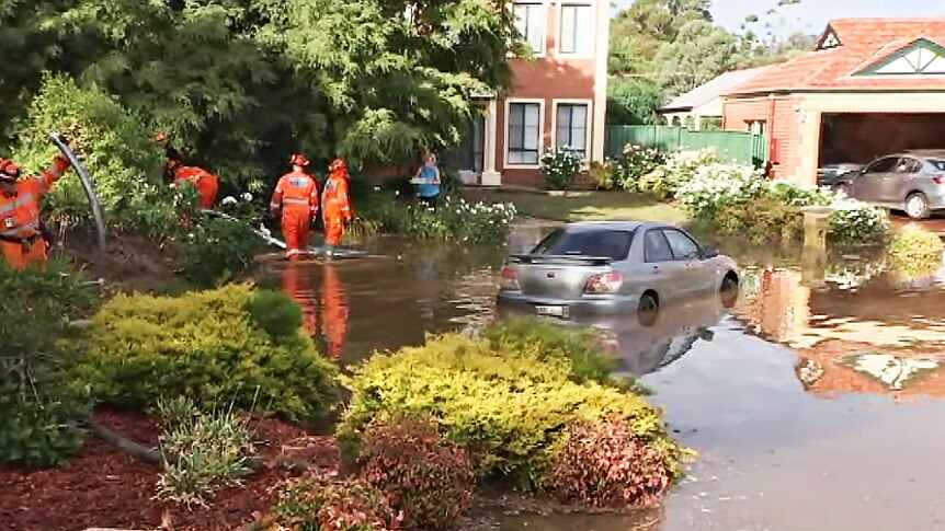 Emergency workers and a submerged car