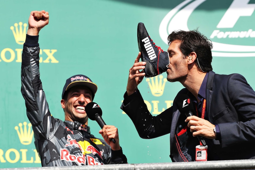 Mark Webber does a shoey in front of Daniel Ricciardo