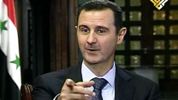 Bashar al-Assad speaks during a TV interview.