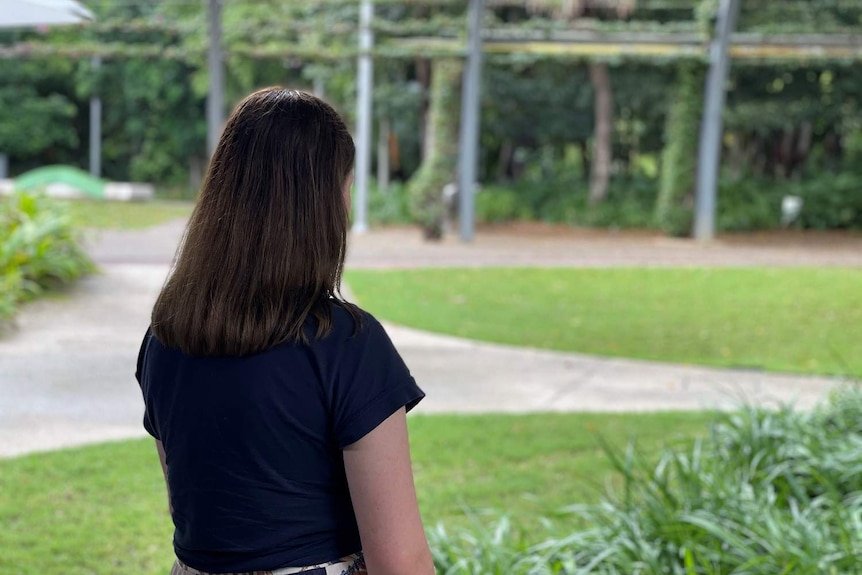 A woman faces away from the camera.