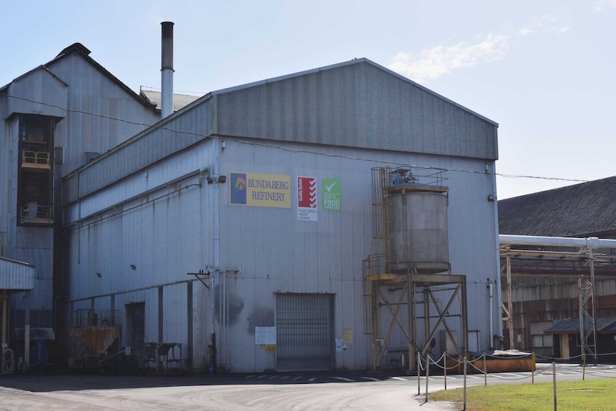 The grey corrugated Bundaberg Sugar refinery building before the start of the crush.