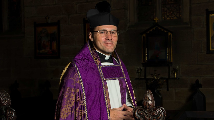 Rector Daniel Dries wearing purple cope in Anglican church.