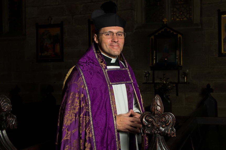 Rector Daniel Dries wearing purple cope in Anglican church.