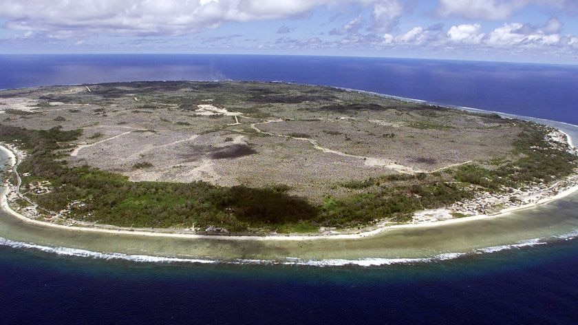 Aerial view of Nauru shows a small, sparsely populated island surrounded by ocean.