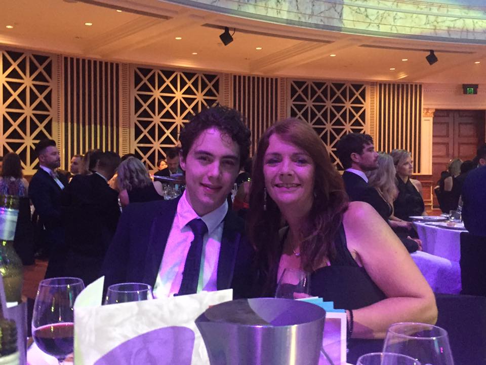 Jarrad Madgwick sits at a table with Kathleen Madgwick