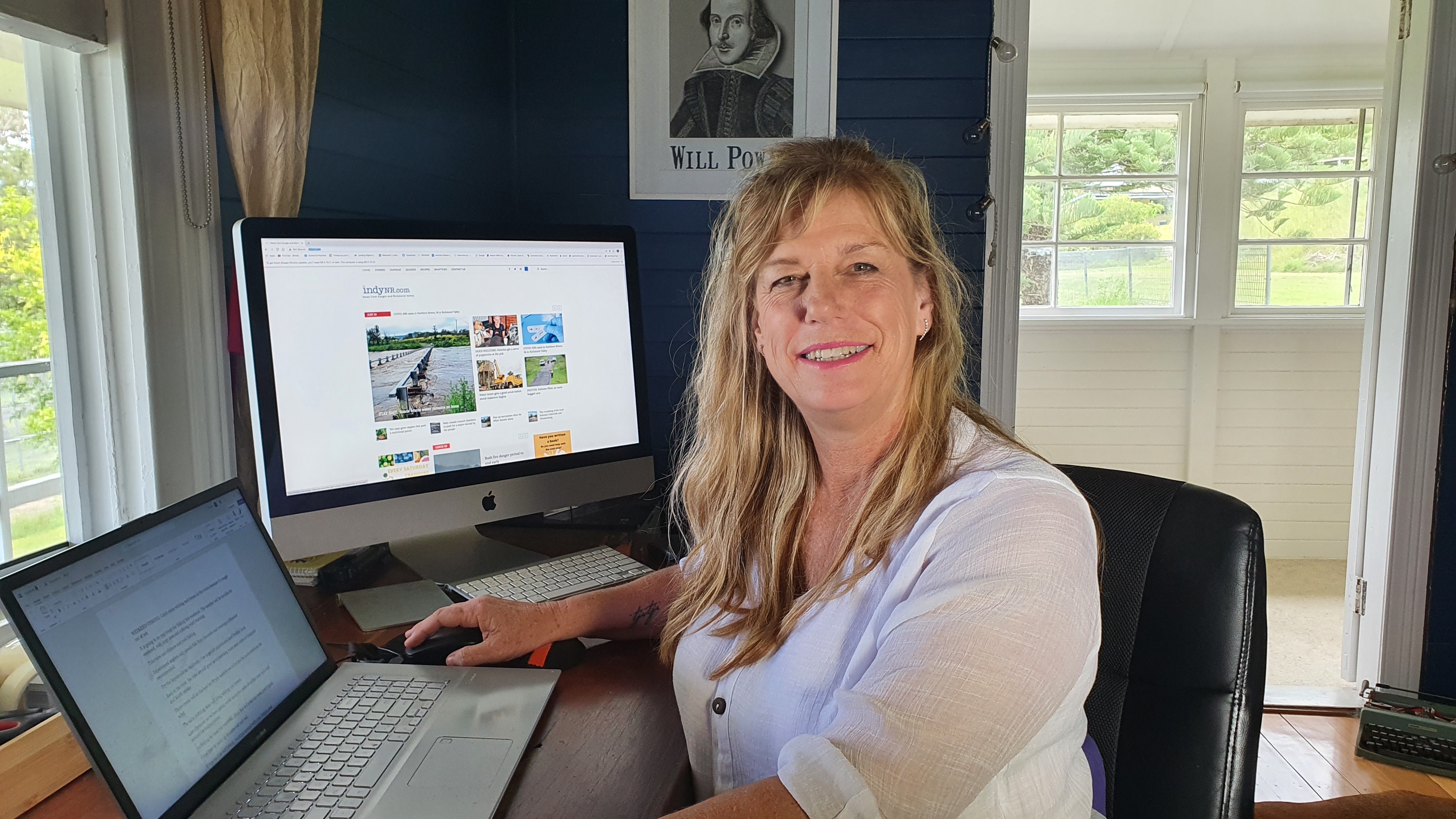 Susanna Freymark sits at her laptop computer in her home office. A screen shows the content on her website.