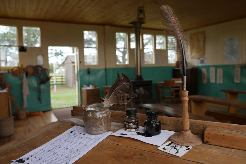 Ink and quill inside an old classroom