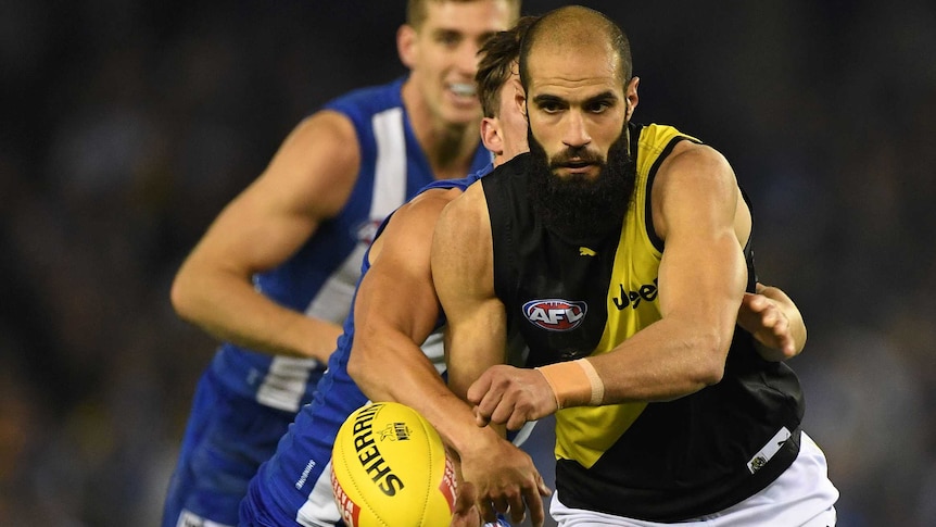 Richmond's Bachar Houli and Nathan Hrovat of the Kangaroos contest the ball