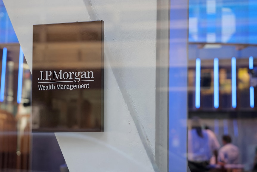 A close-up of an expensive-looking plaque with the words "J.P.Morgan Wealth Management" affixed to a building.