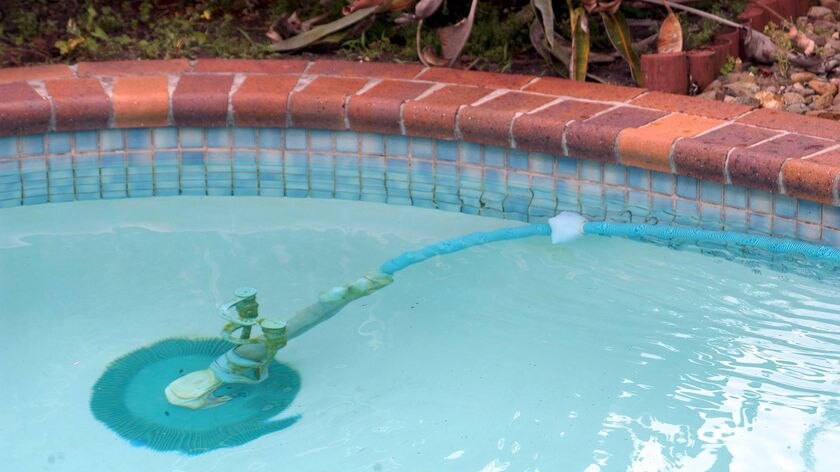 A Kreepy Krauly makes its way around a swimming pool